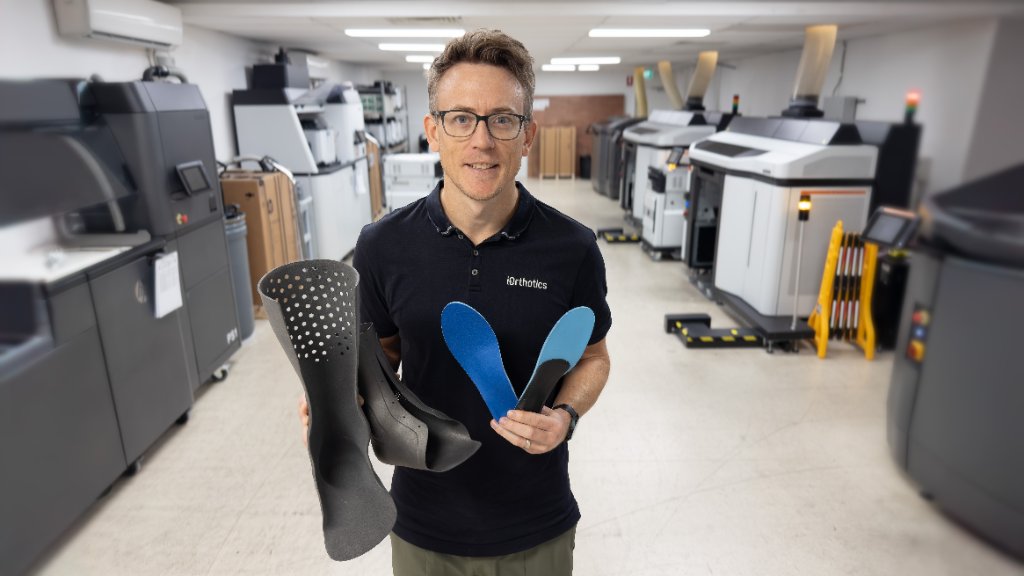 Dean Hartley, Director, with 3D-printed iOrthotics devices