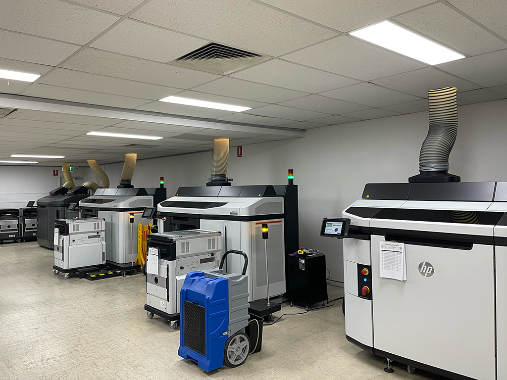 Inside the iOrthotics 3D print bureau, rows of HP Multi Jet Fusion systems producing orthotic devices