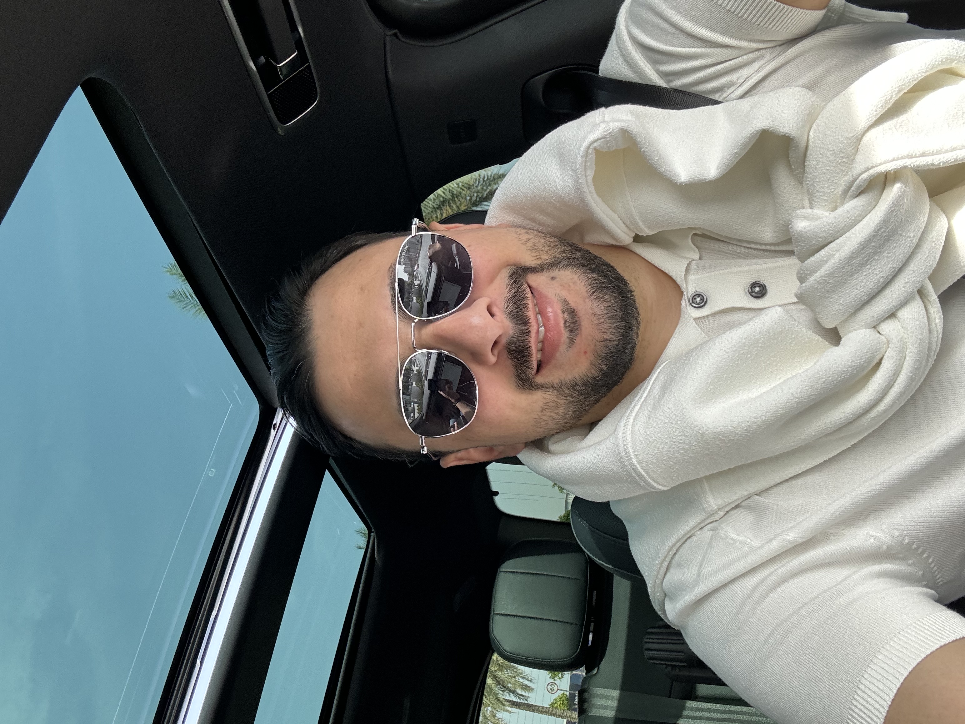Matteo Stefano Ragusa smiling in a luxury car
