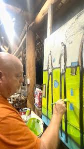 William DeBilzan painting a green canvas
