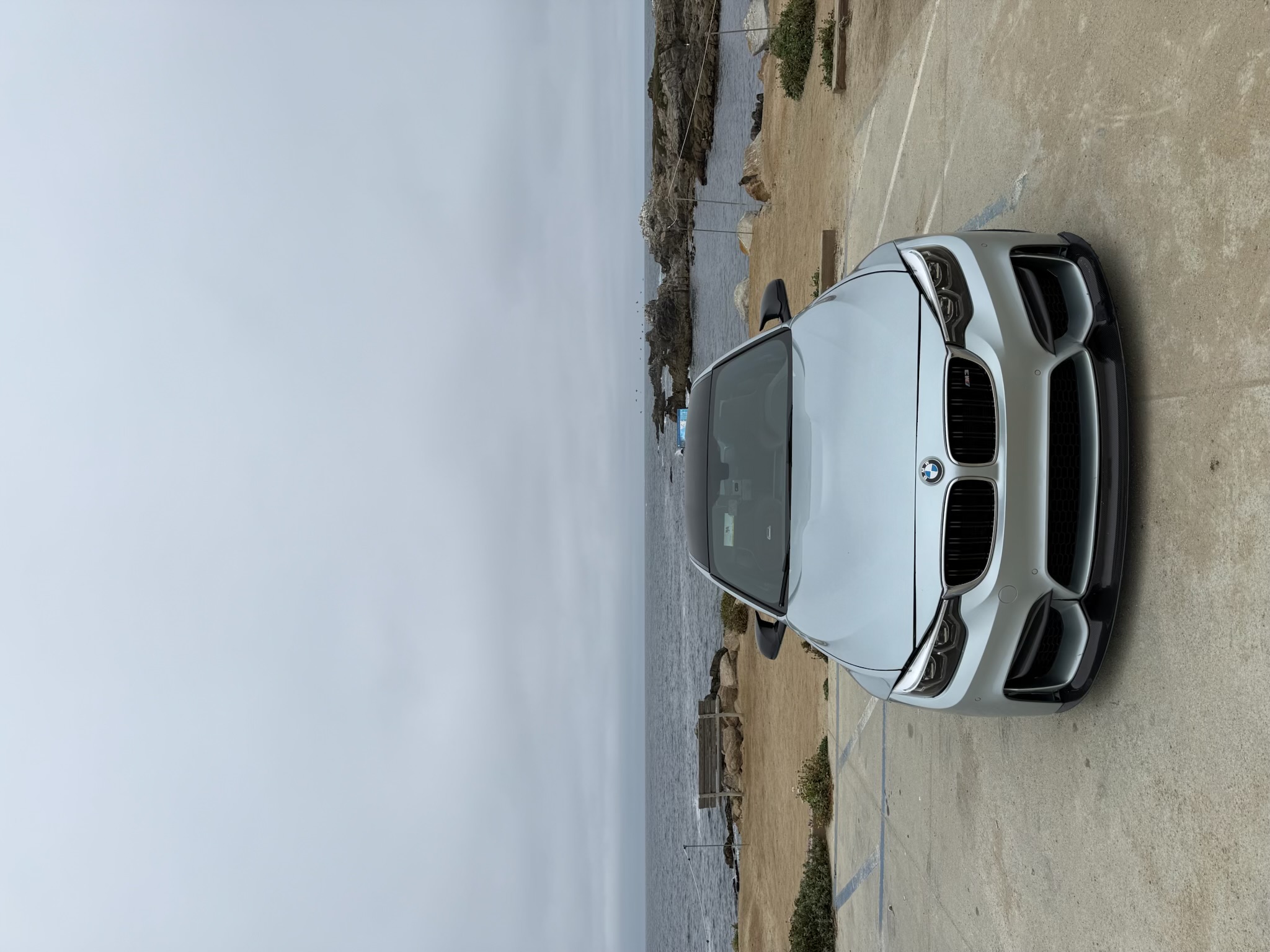 ROLLNUPP — silver BMW M3 overlooking the coast