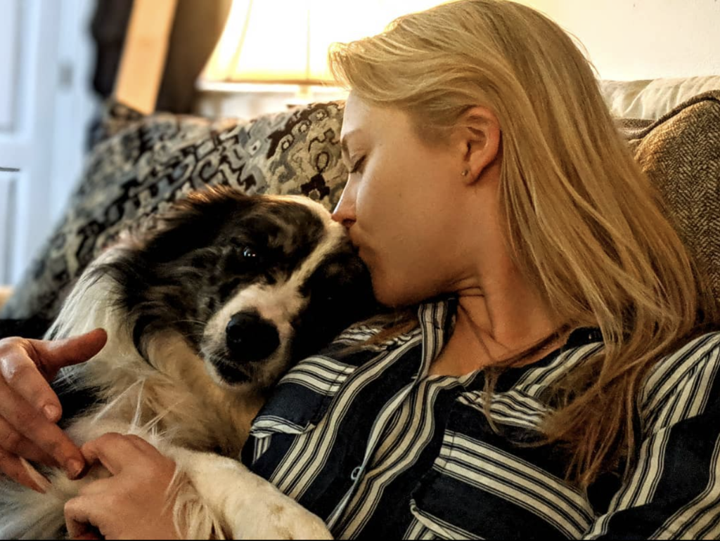 Dr. Eve kissing Apollo on the head at home