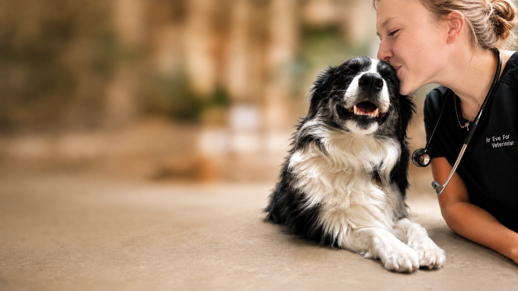 Dr. Eve Fontanella kissing her Border Collie Apollo on the head