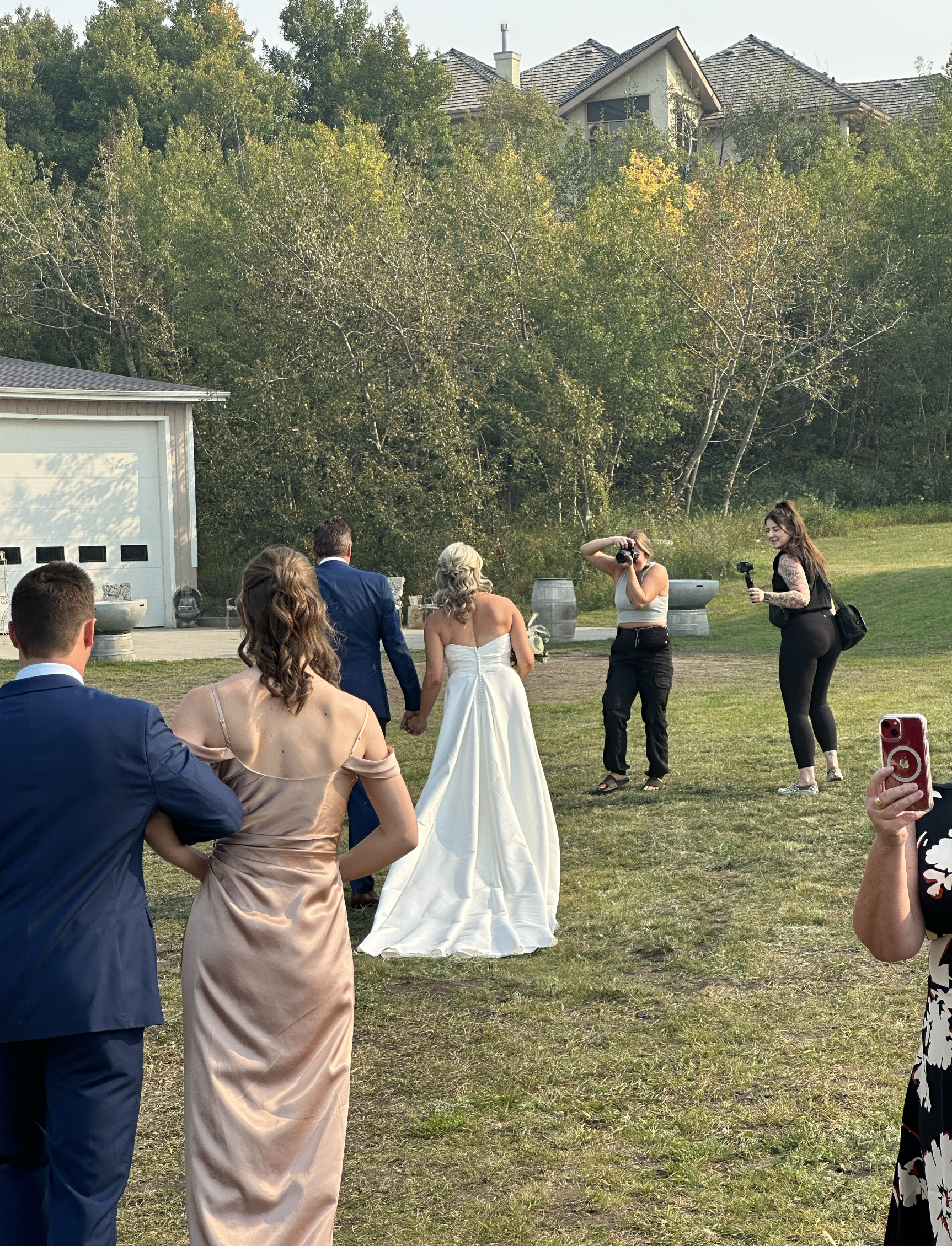 Taylor and a second shooter filming a couple walking hand in hand