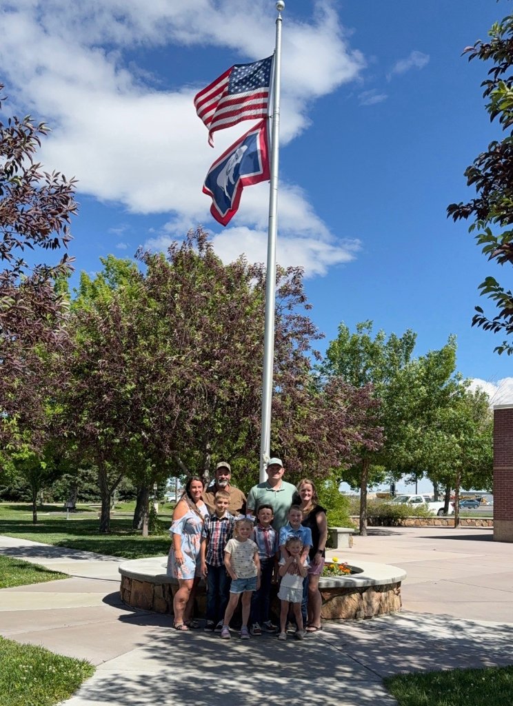 Family gathering by the flagpole