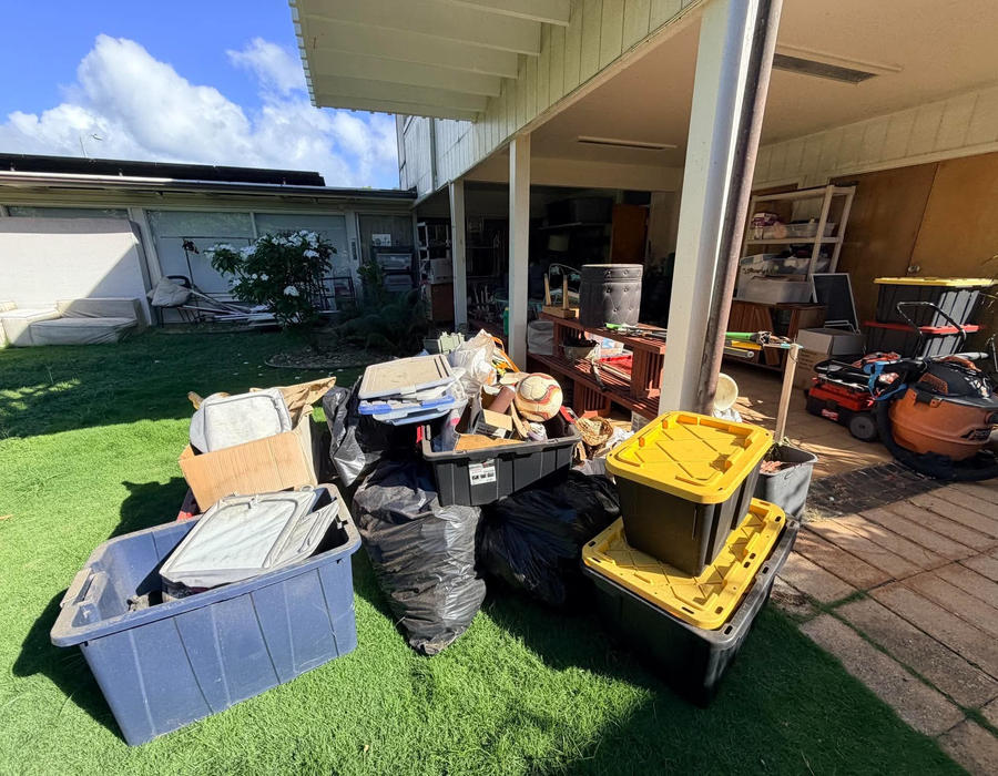 Junk piled on a Kahala patio before removal — view 1