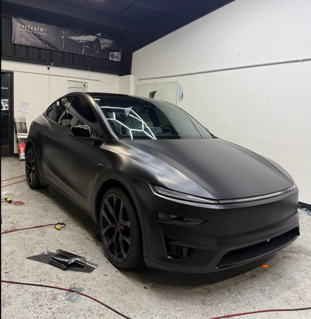 Dark grey Tesla Model Y with PPF in the Royal Window Tint detailing bay