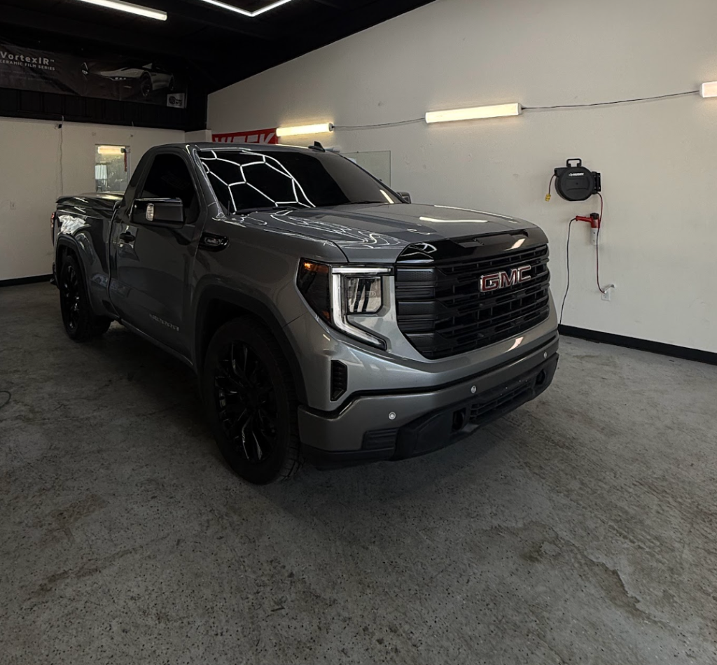 GMC Sierra in the Royal Window Tint shop with heat gun ready for tint removal