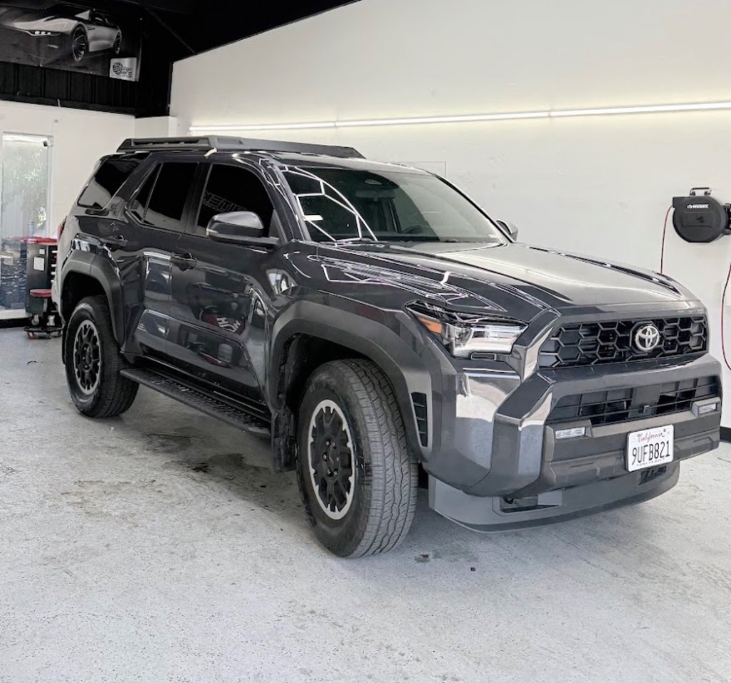 Dark gray Toyota 4Runner SUV with tinted windows inside the garage