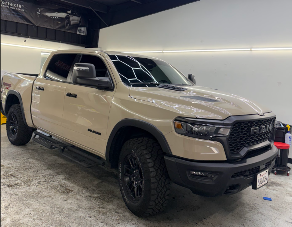 Tan RAM Rebel pickup truck with tinted windows inside the Royal Window Tint shop