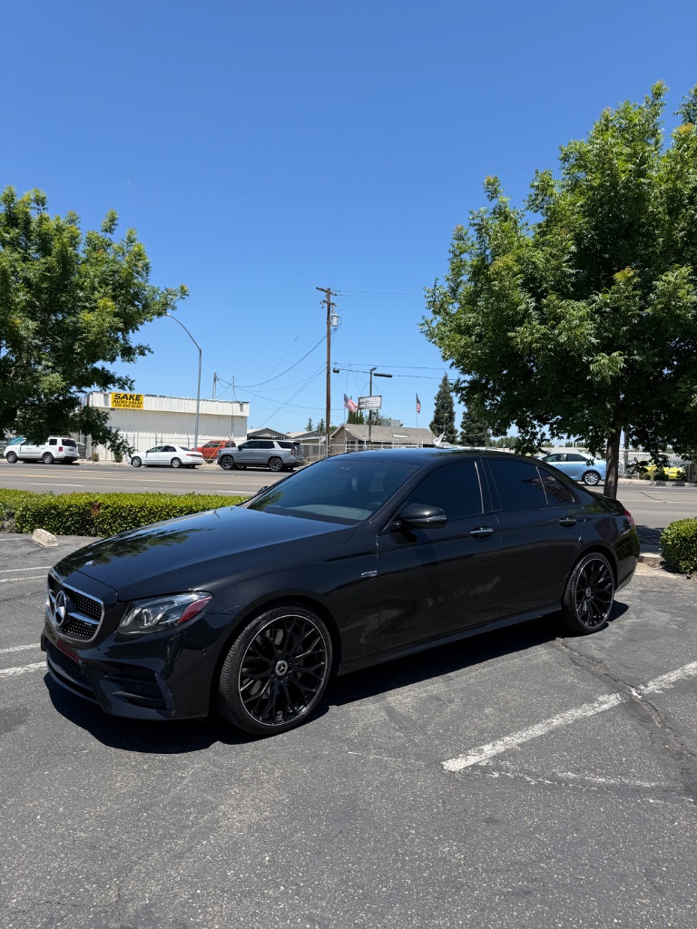 Black Mercedes-Benz sedan with heavily tinted windows parked outdoors