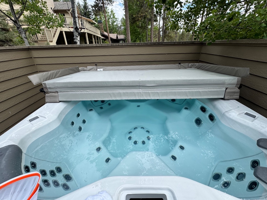 Hot tub with cover partially removed