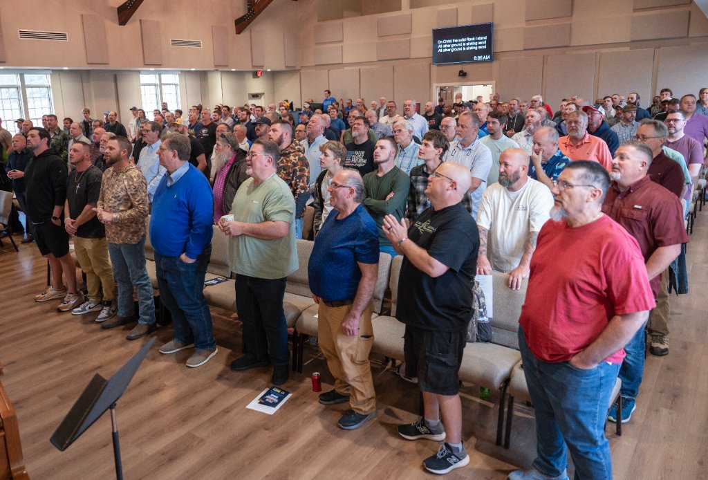 Men worshipping together at a Real Momentum gathering