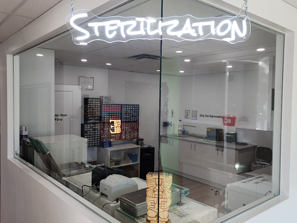 Sterilization room with neon sign and tiki carving