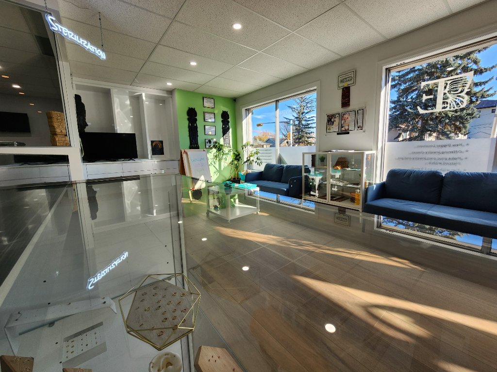 Tribal Expression studio interior with green accent wall and tiki totems