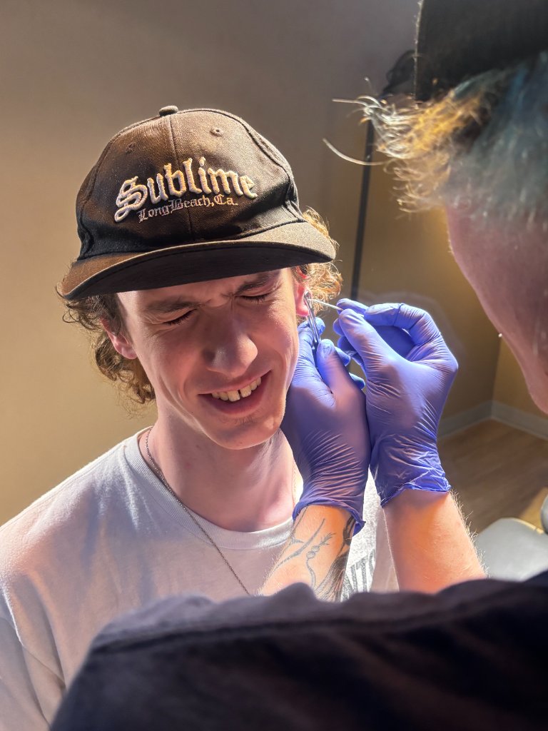 Tribal Expression piercing room with logo mural