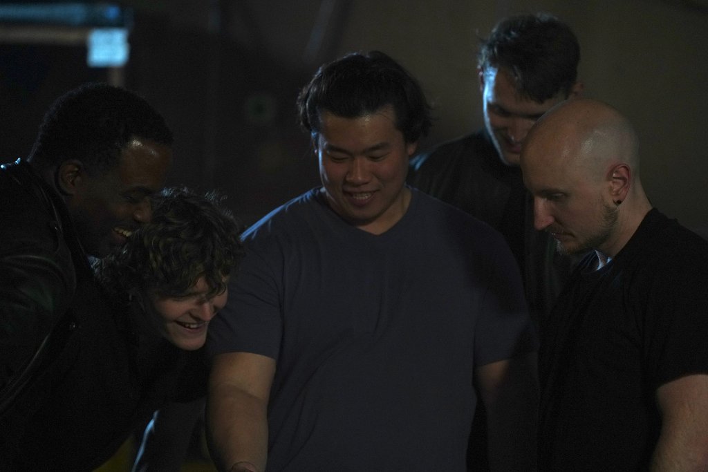 Crew gathered around monitor