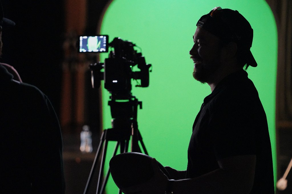 Silhouette of DP with camera and green screen