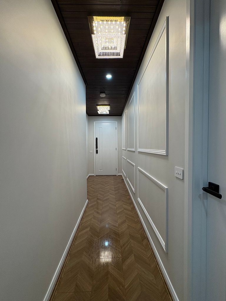 Completed residential hallway with herringbone flooring and wainscoting after a final builders clean in Melbourne