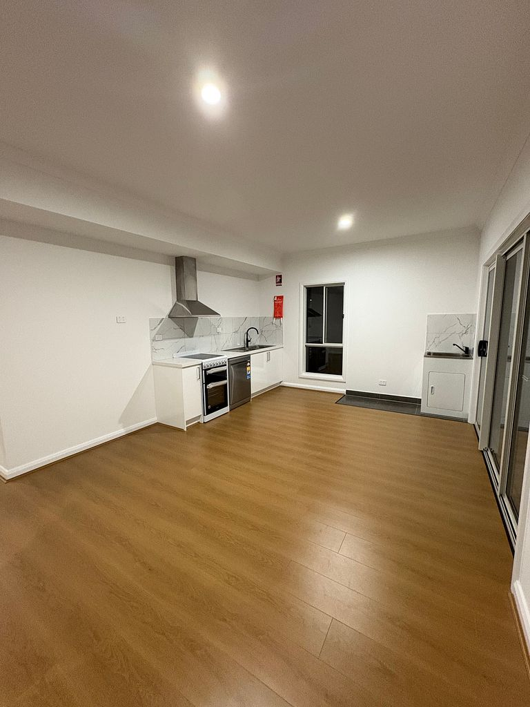 Open-plan kitchen and living area in a completed residential home after a final builders clean in Melbourne