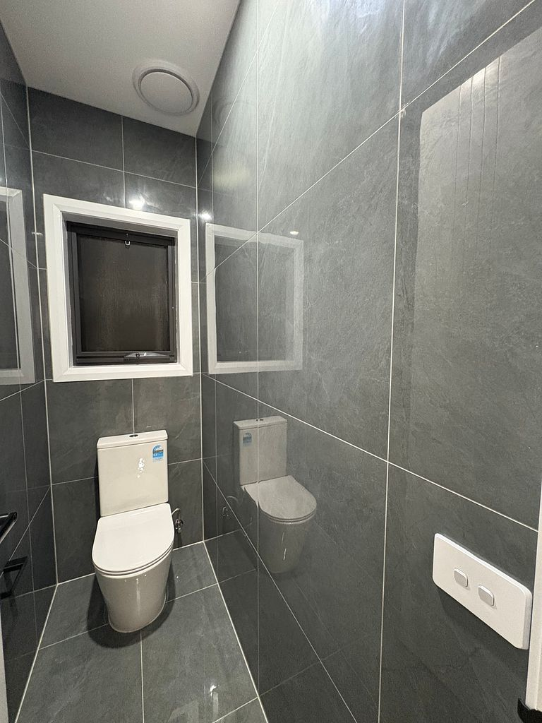 Completed powder room with tiled walls after a final builders clean