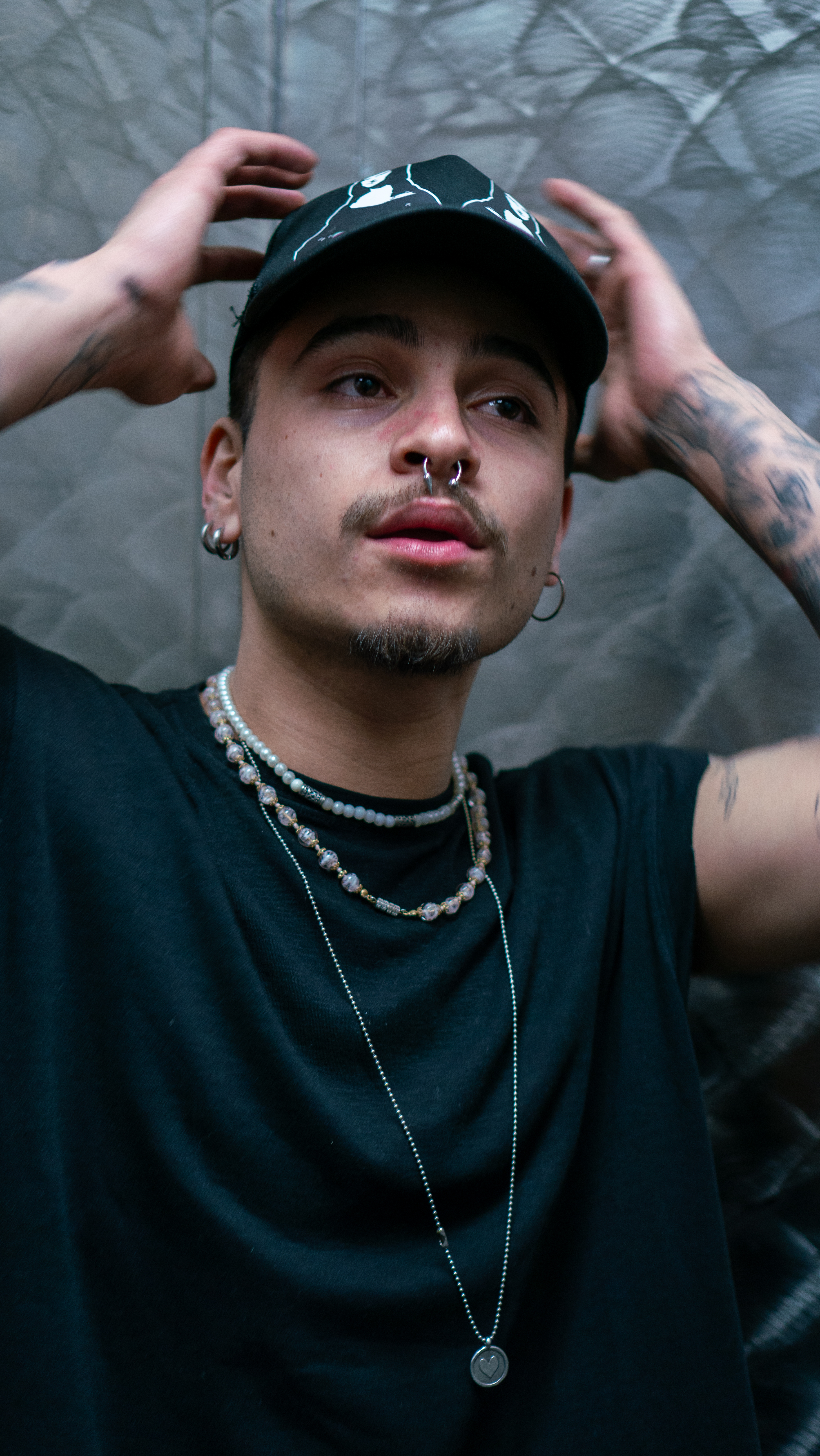 Devincii — side profile with cap and pearl chains