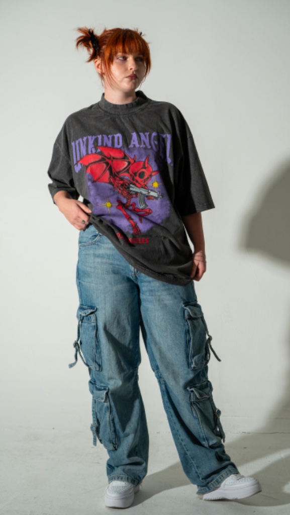Female model in oversized graphic tee with wide-leg cargo jeans