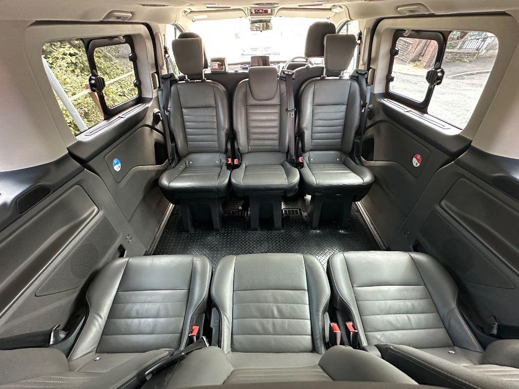 Ow's Travel minibus interior — comfortable leather seating