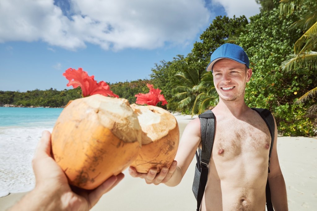 Friends toasting with coconut drinks on a Philippine beach