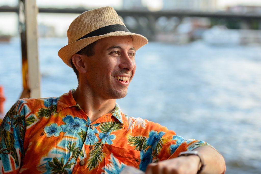 Tourist in a fedora and floral shirt by the Philippine coast