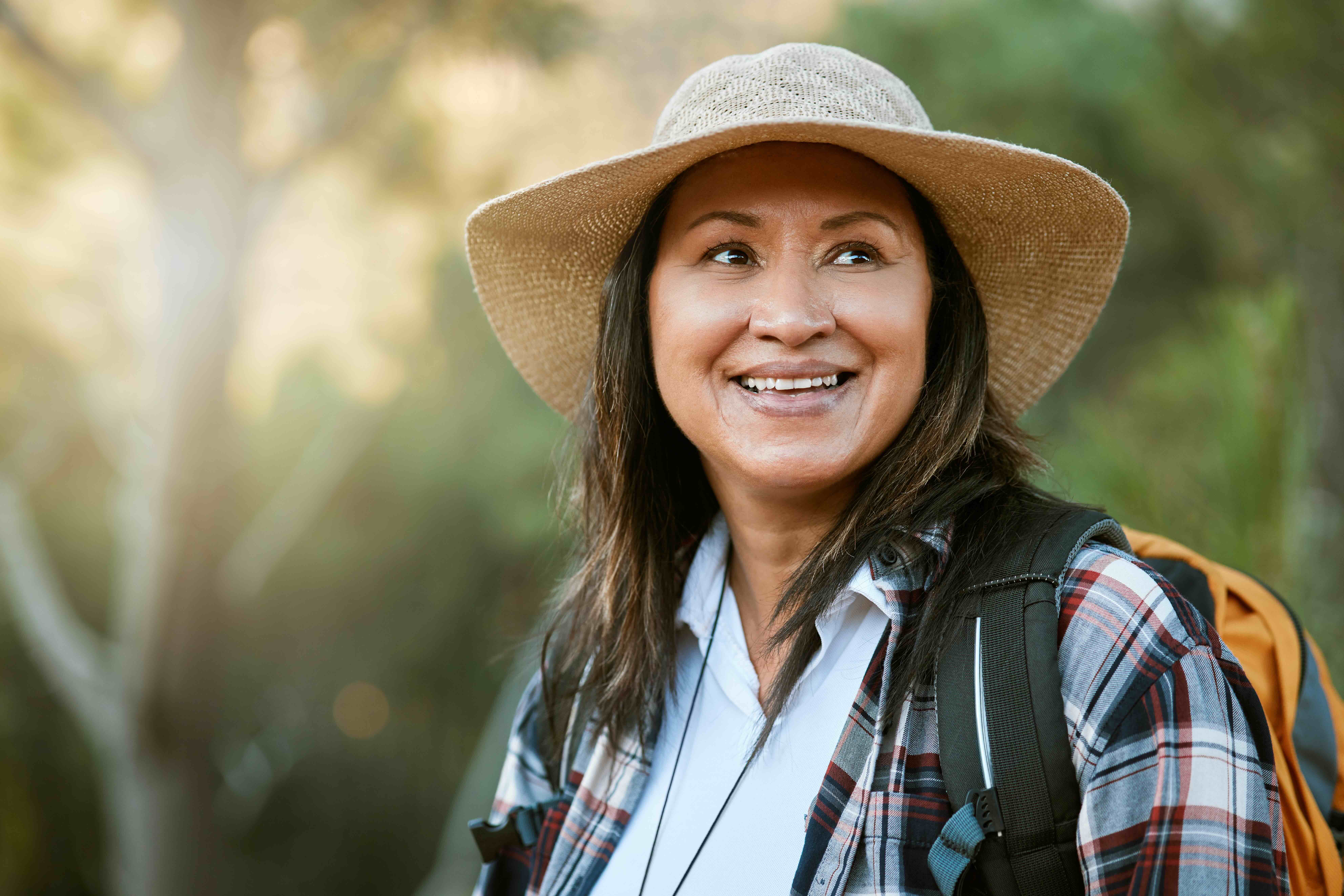 Smiling woman hiking in nature with a backpack