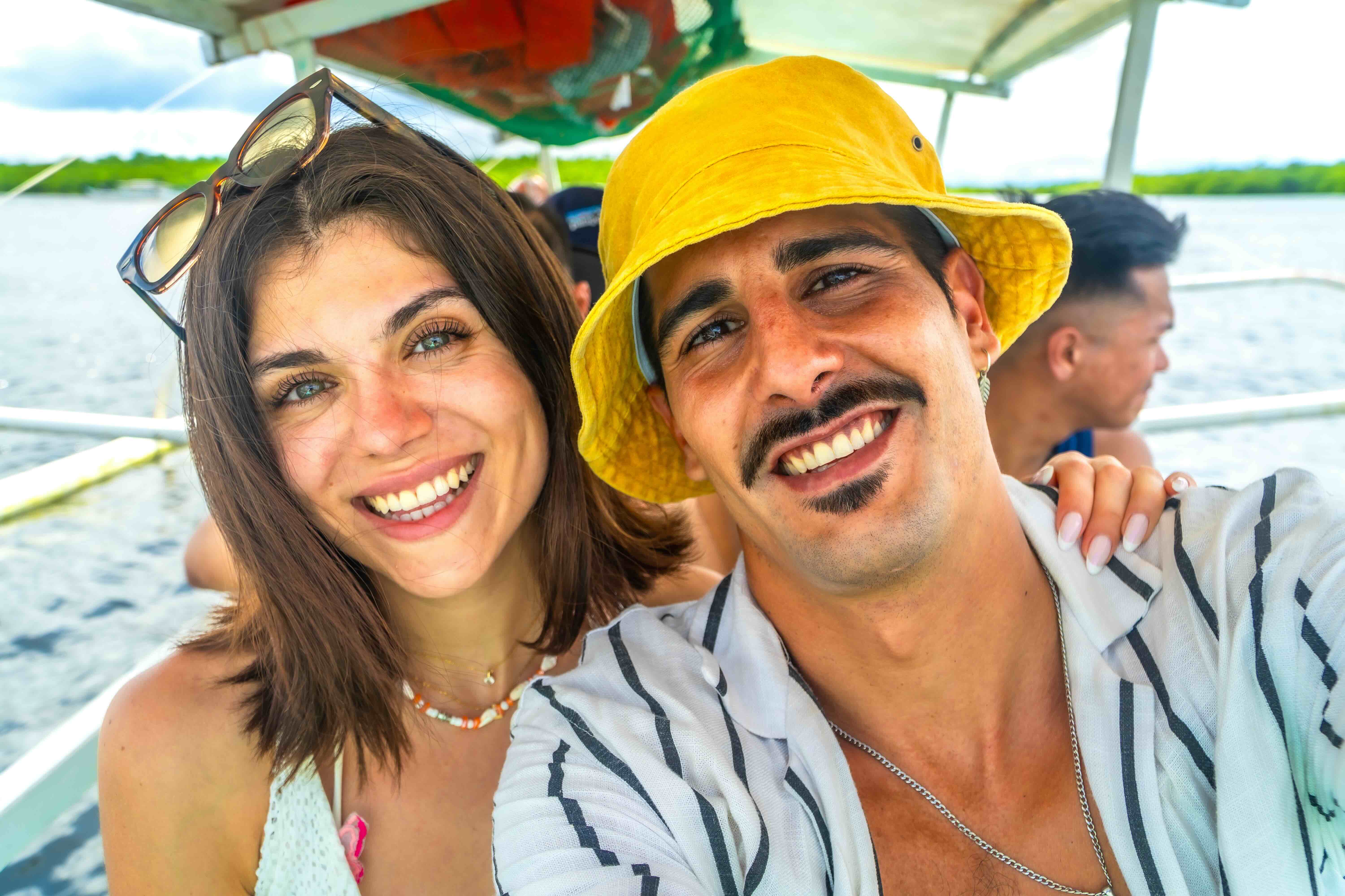 Happy couple taking a selfie on a boat trip in the Philippines