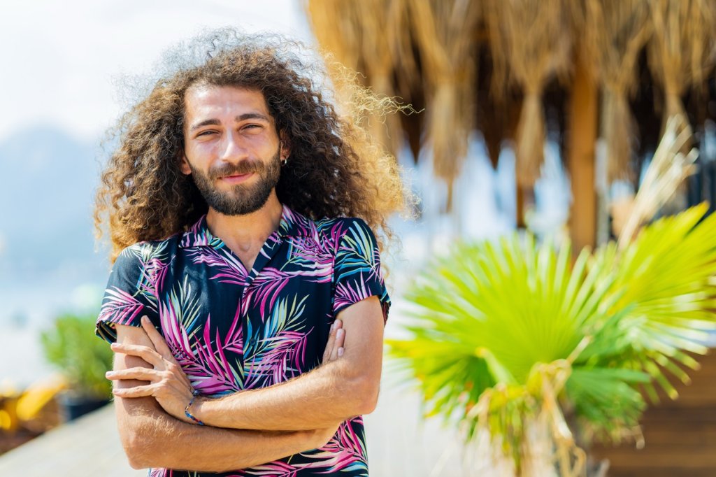 Smiling traveler in a floral shirt enjoying the outdoors