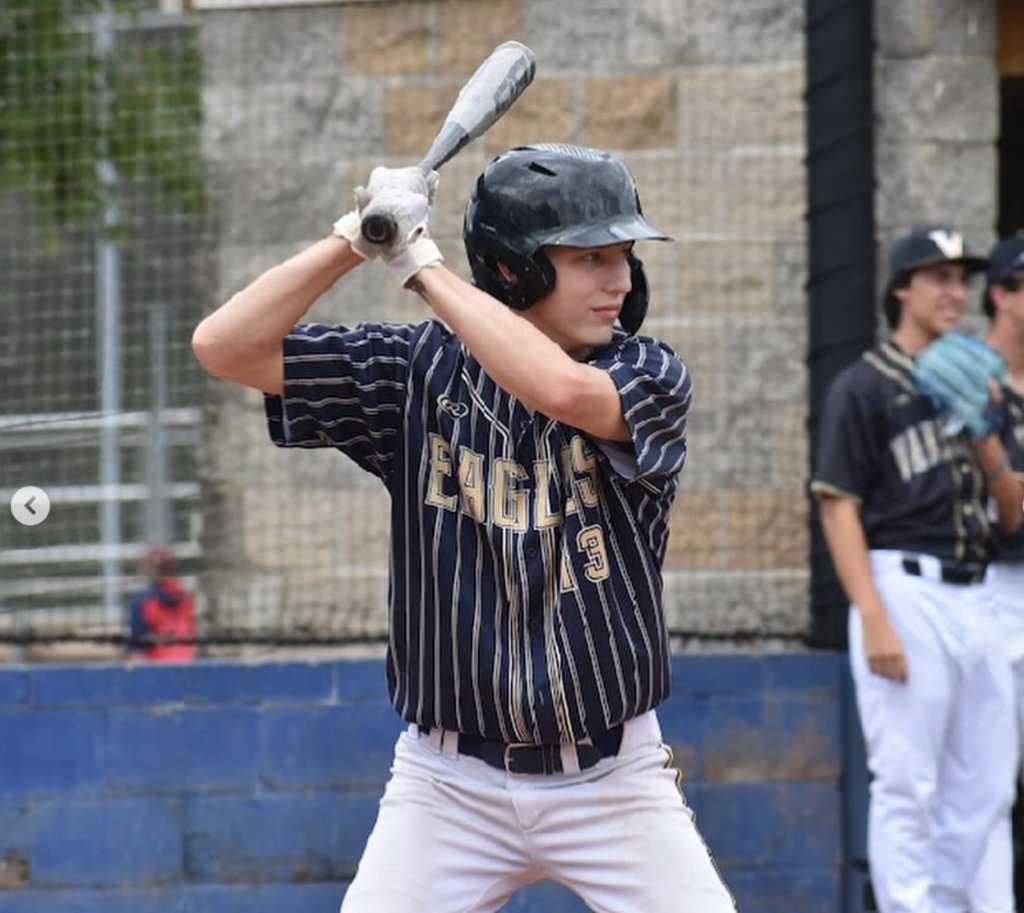 Baseball player mid-swing action shot