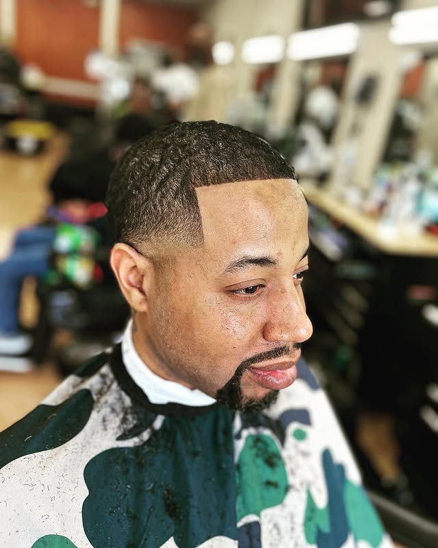 Afro puff with skin fade at Greene's Barber Service