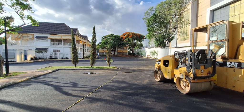 Completed road works with construction equipment.