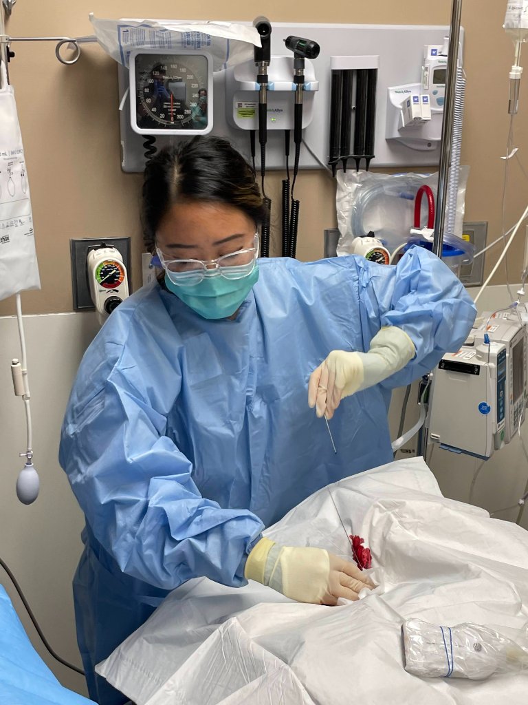 Riverside EM physician performing a procedure in the trauma bay