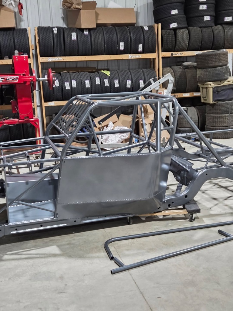 Bare DeVilbiss chassis frame on the build cart