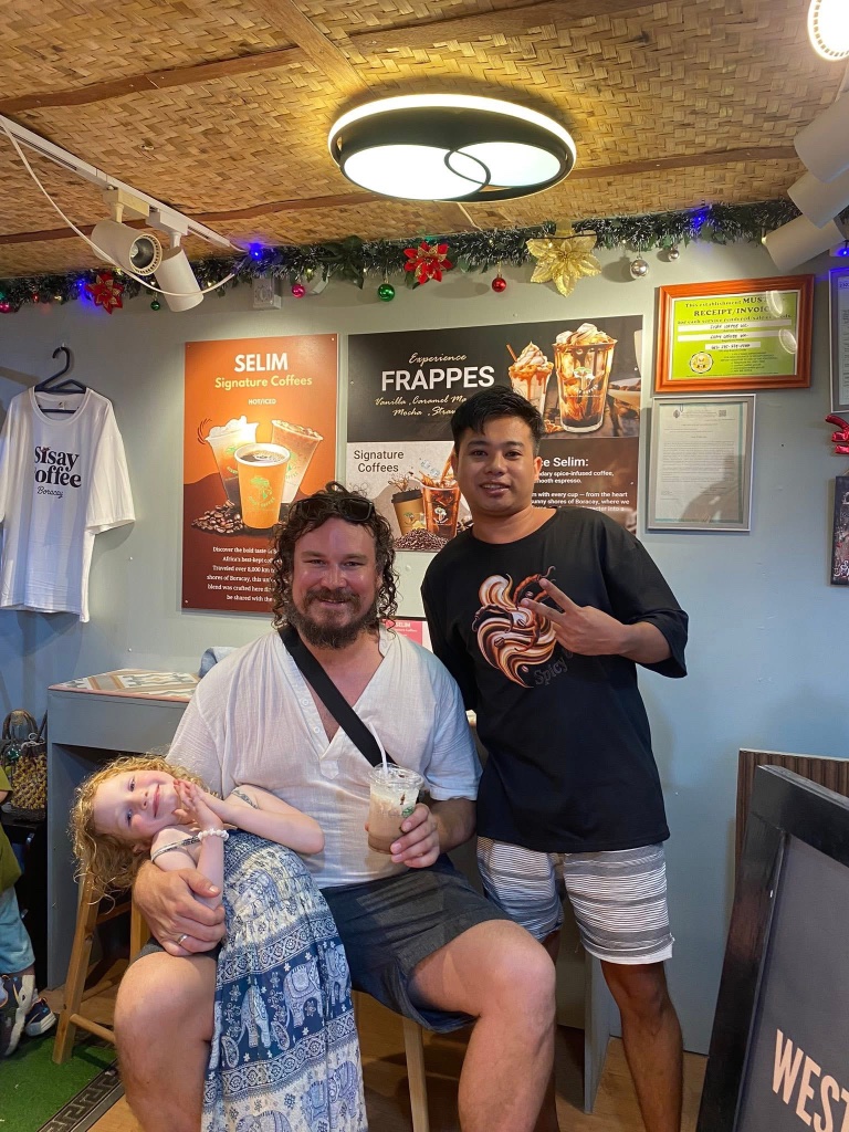 Two friends posing with iced coffee at the Boracay shop