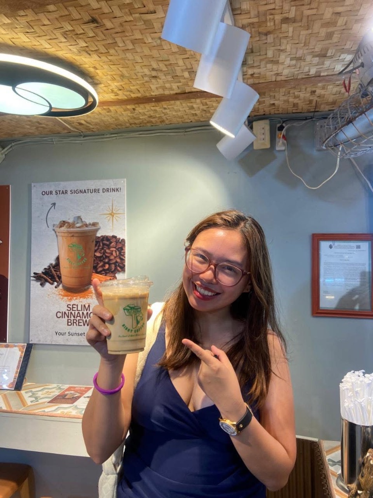 Customer holding an iced Sisay Coffee at the Boracay shop