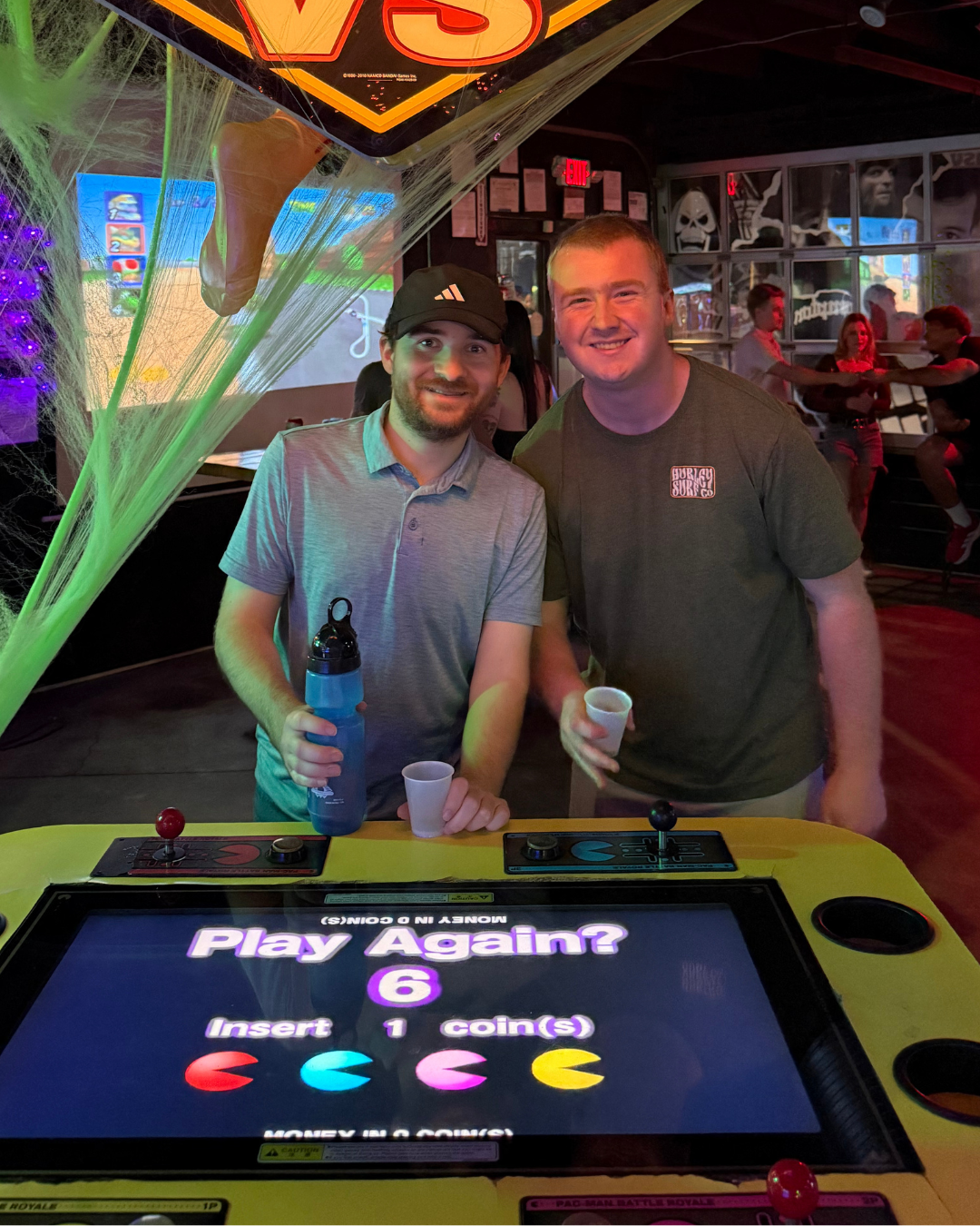 Social Circle members playing Pac-Man at an arcade