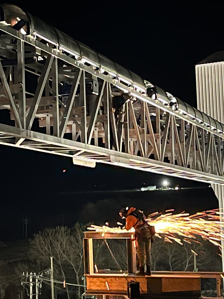 Industrial emergency call-out repair with grinder at night