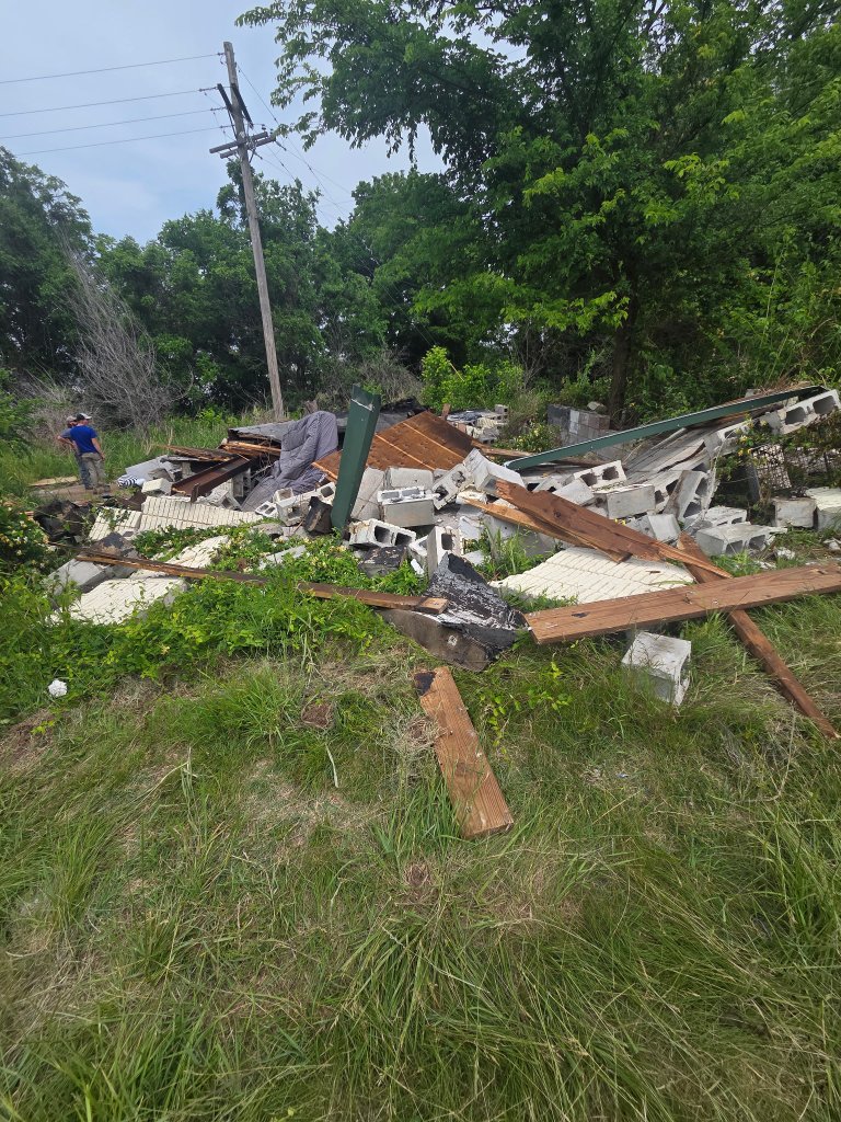 Demolition debris and yard waste pile ready for removal