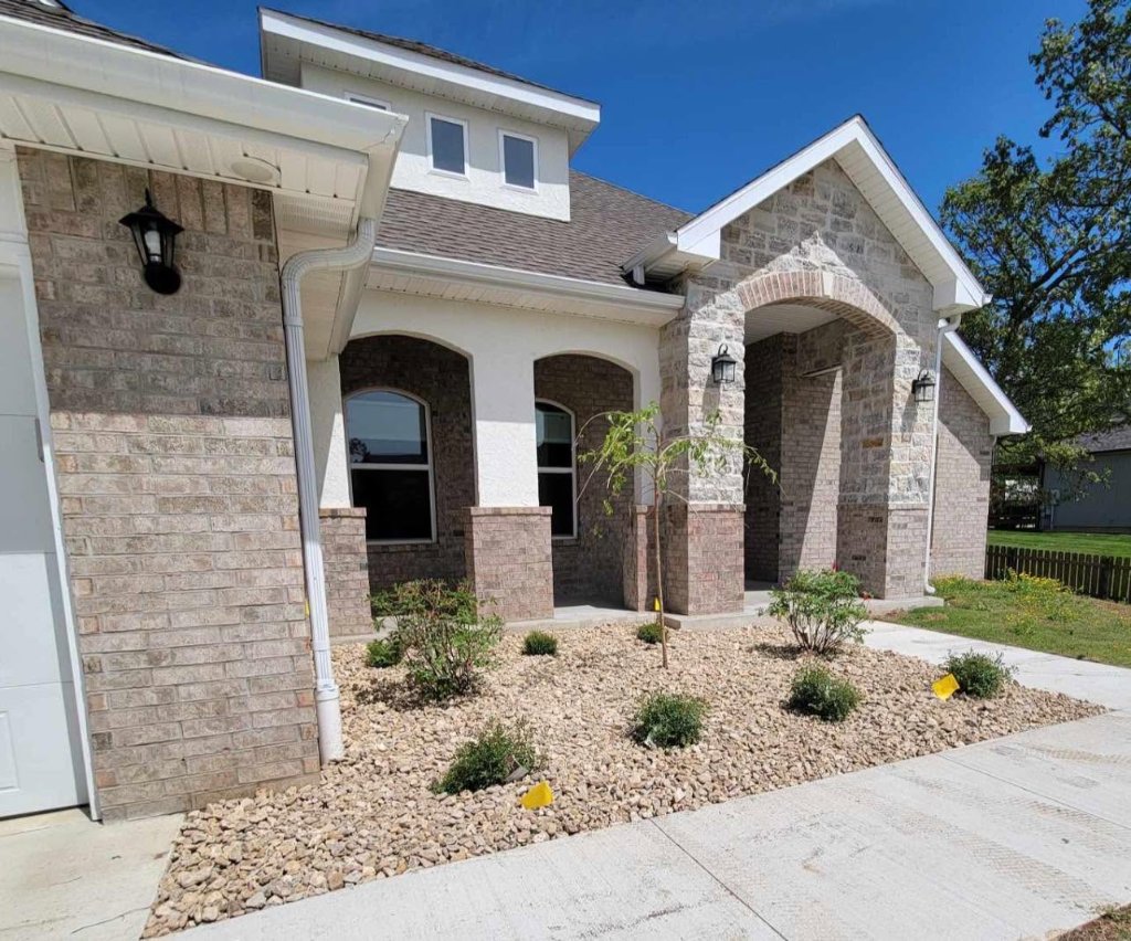 New construction home with rock landscape bed installation