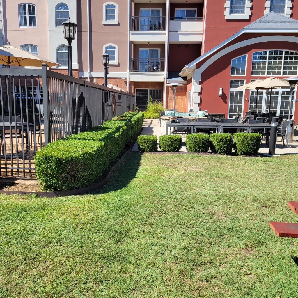Estate lawn striped with mower and red brick home