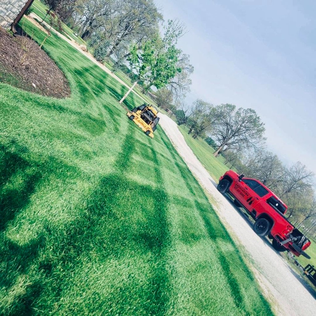 Evergreen Estates truck and trailer fleet on lawn