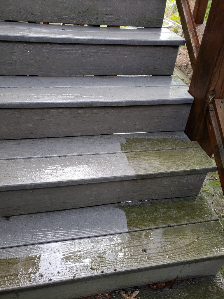 Stairs half power-washed showing clean vs dirty contrast