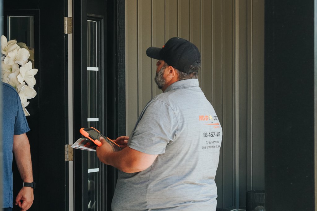 Never Dark Carolinas technician conducting a free power needs assessment at a South Carolina home