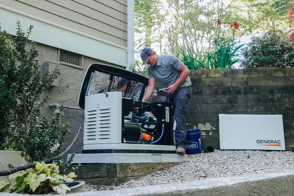 Never Dark Carolinas factory-trained technician performing annual maintenance on a Generac standby generator