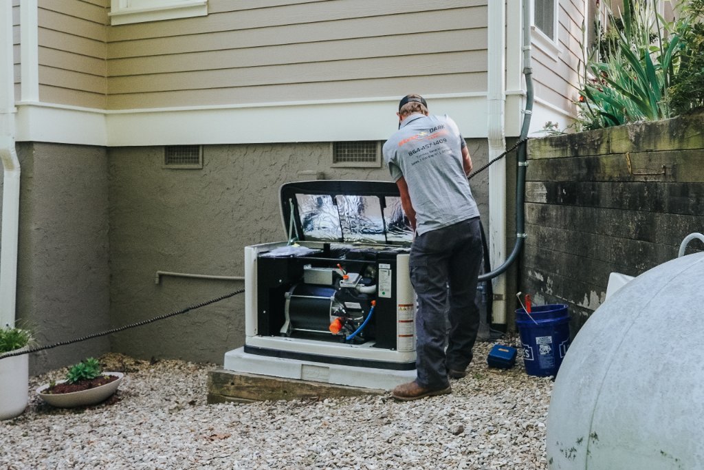 Never Dark Carolinas technician servicing standby generator engine internals during annual maintenance